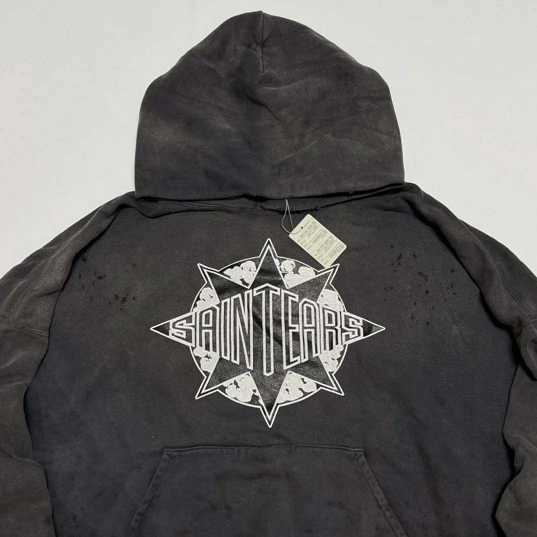 DENIM TEARS x SAINT Mxxxxxx SAINT TEARS Hoodie/BLK Five-pointed star cotton hole-in-the-dark distressed hoodie, washed black S-XL Assute dyeing, whole piece sprayed with horse fade/horse weight, co-branded main mark/cotton wash mark/cherub mark, many hanging holes on the front and rear panels, the original version has the same loose fit